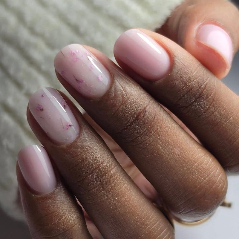 Nude pink nails with pressed dried flowers