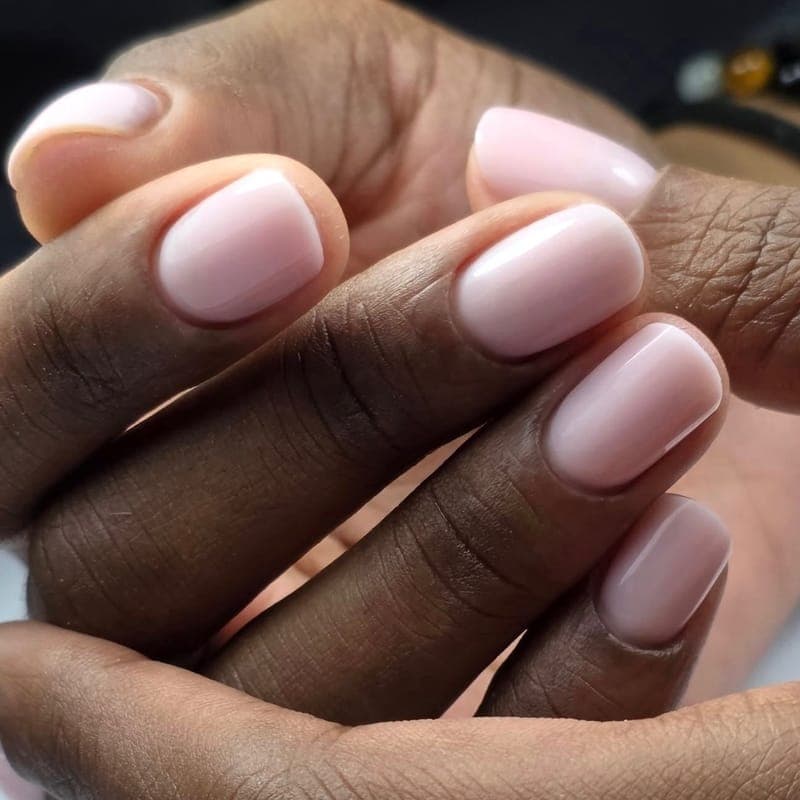 Short rounded nails in a soft milky pink