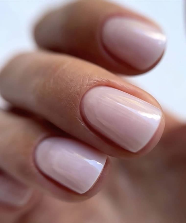 Short squoval fingernails in a sheer milky nude